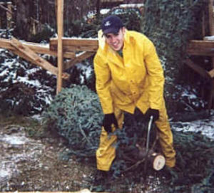 Chris Cutting Christmas Tree Trunk