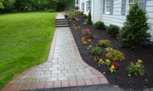 A paved walkway in front of a house.